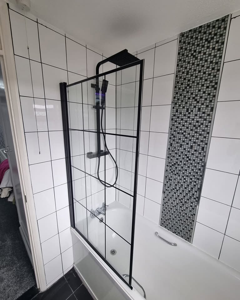 Bath with new black-framed shower screen and black rainfall shower fitted